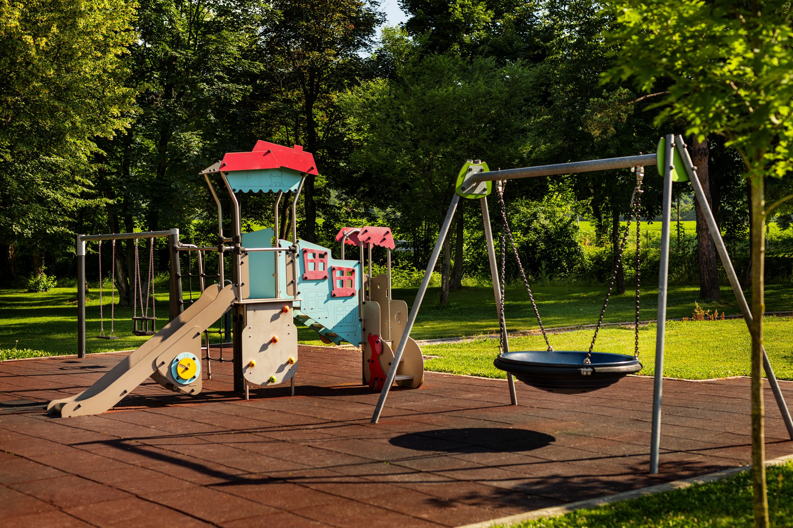 A playground with a swing set and climbing structures.