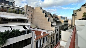 A multi-story building with balconies and a red-tiled roof. - Hotel Achillion (Piraeus)
