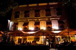 A hotel with multiple balconies, outdoor seating, and a visible restaurant named "brasserie."