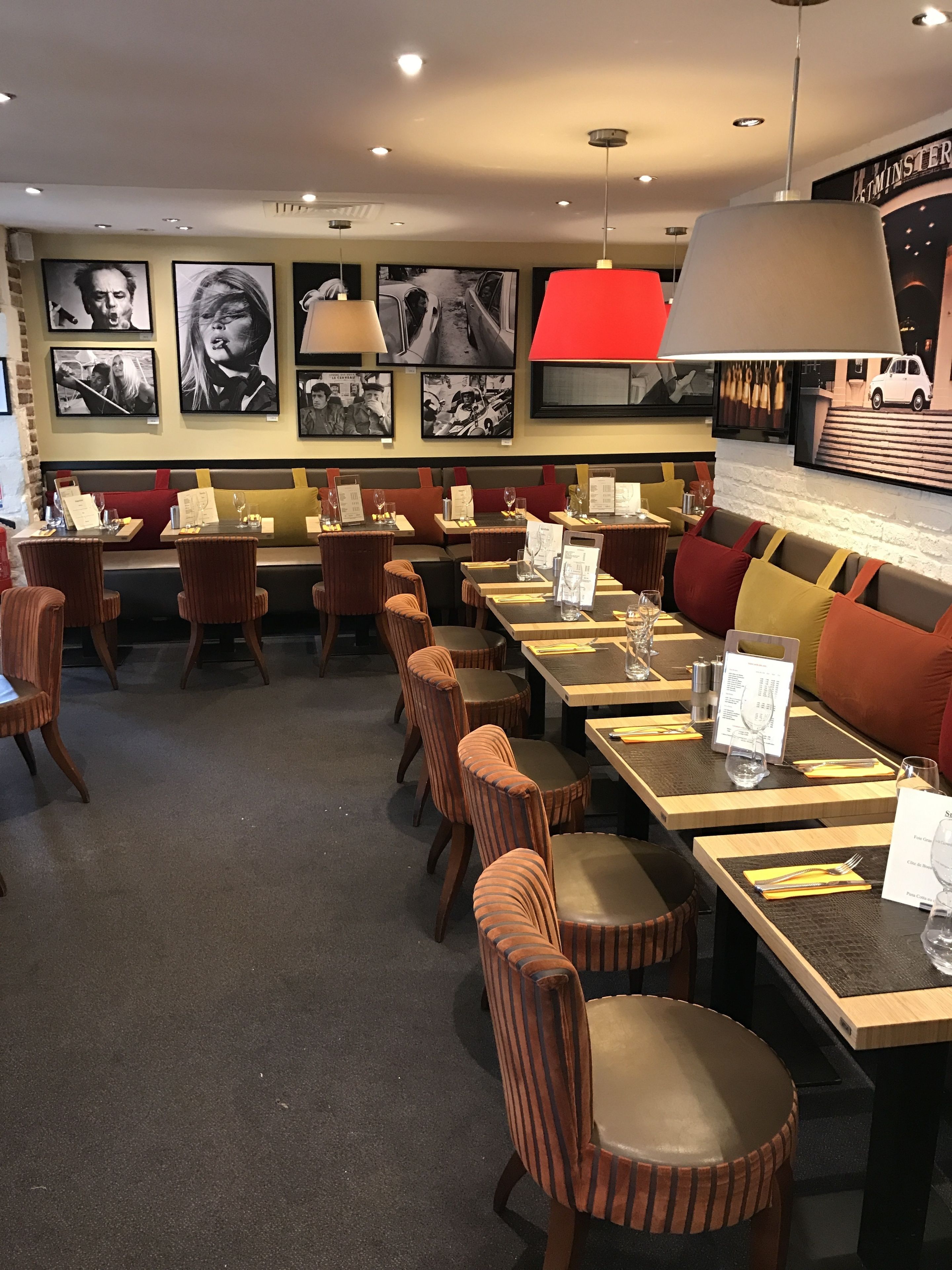 A restaurant interior with booths, tables, and chairs.