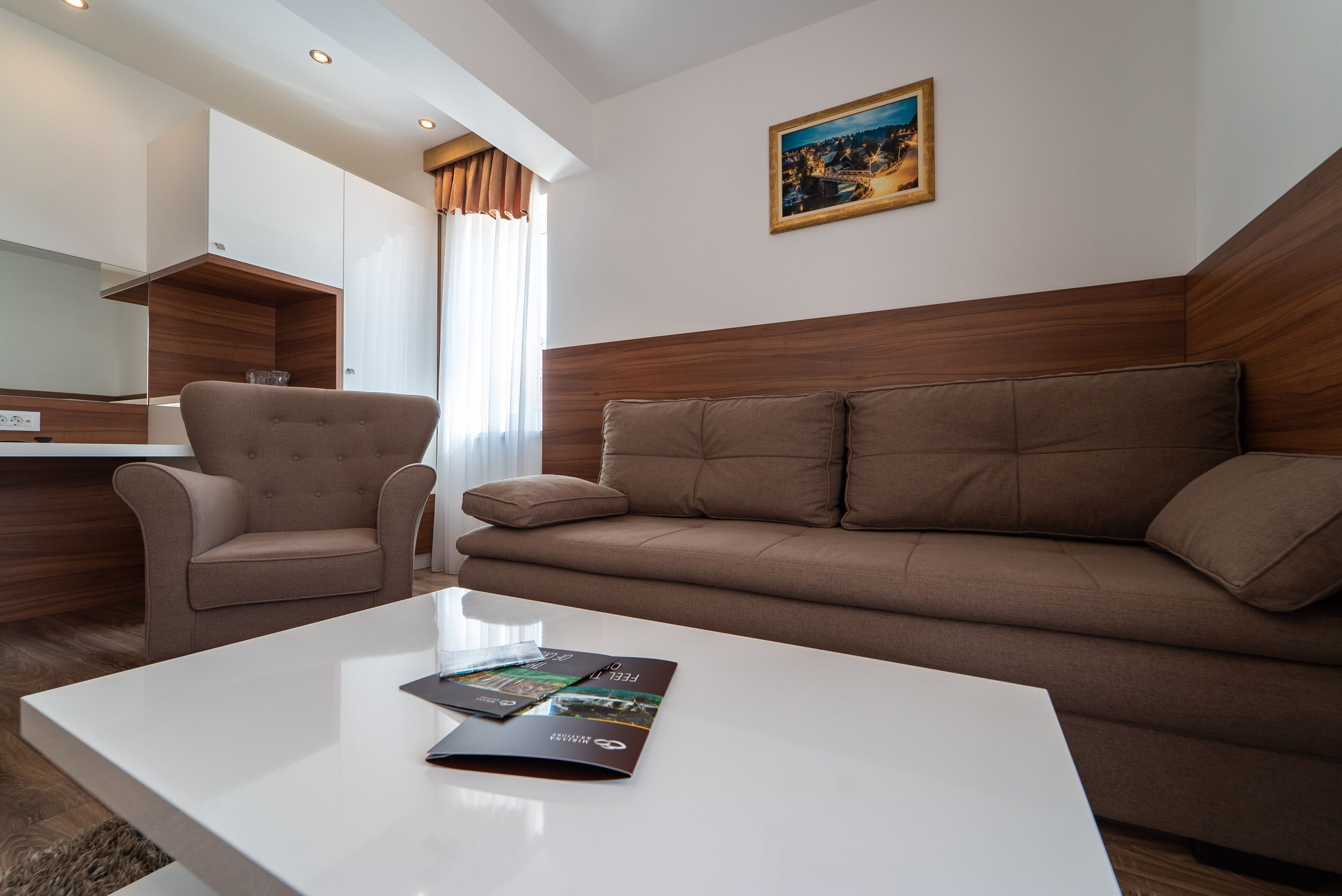 A modern living room with a sofa, a coffee table, and a chair.