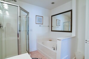 A bathroom with a glass shower enclosure, a bathtub, and a large mirror. - TURTLE BAY 23 3 Bedroom Holiday Home By My Ocean Rentals (Folly Beach)
