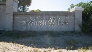 A sign with the words "Marsh Winds" on a stone wall. - Marsh Winds 2A 3 Bedroom Holiday Home By My Ocean Rentals (Folly Beach)