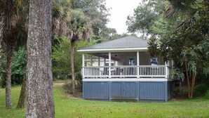A house with a covered porch, surrounded by trees and grass. - E Huron 308 4 Bedroom Holiday Home By My Ocean Rentals (Folly Beach)