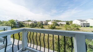 A residential area with multiple two-story houses, a grassy field, and a clear sky. - Waters Edge Community 95 3 Bedroom Holiday Home By My Ocean Rentals (Folly Beach)