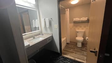 A bathroom with a sink, mirror, and toilet.