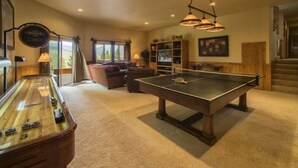 A spacious living area with a pool table, a foosball table, and a comfortable seating area. - Retreat at Summerwood 5 Bedroom Apartment by Key to the Rockies (Dillon)