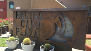 A sign for Marina Capo Plaza with three potted cacti in front. - Studio Suite at Marina Cabo Plaza (Cabo San Lucas)