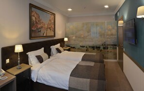 A hotel room with two beds, a painting of a canal scene, a TV, and a large window with a view of boats. - ZENTRUM Hotel (Chisinau)