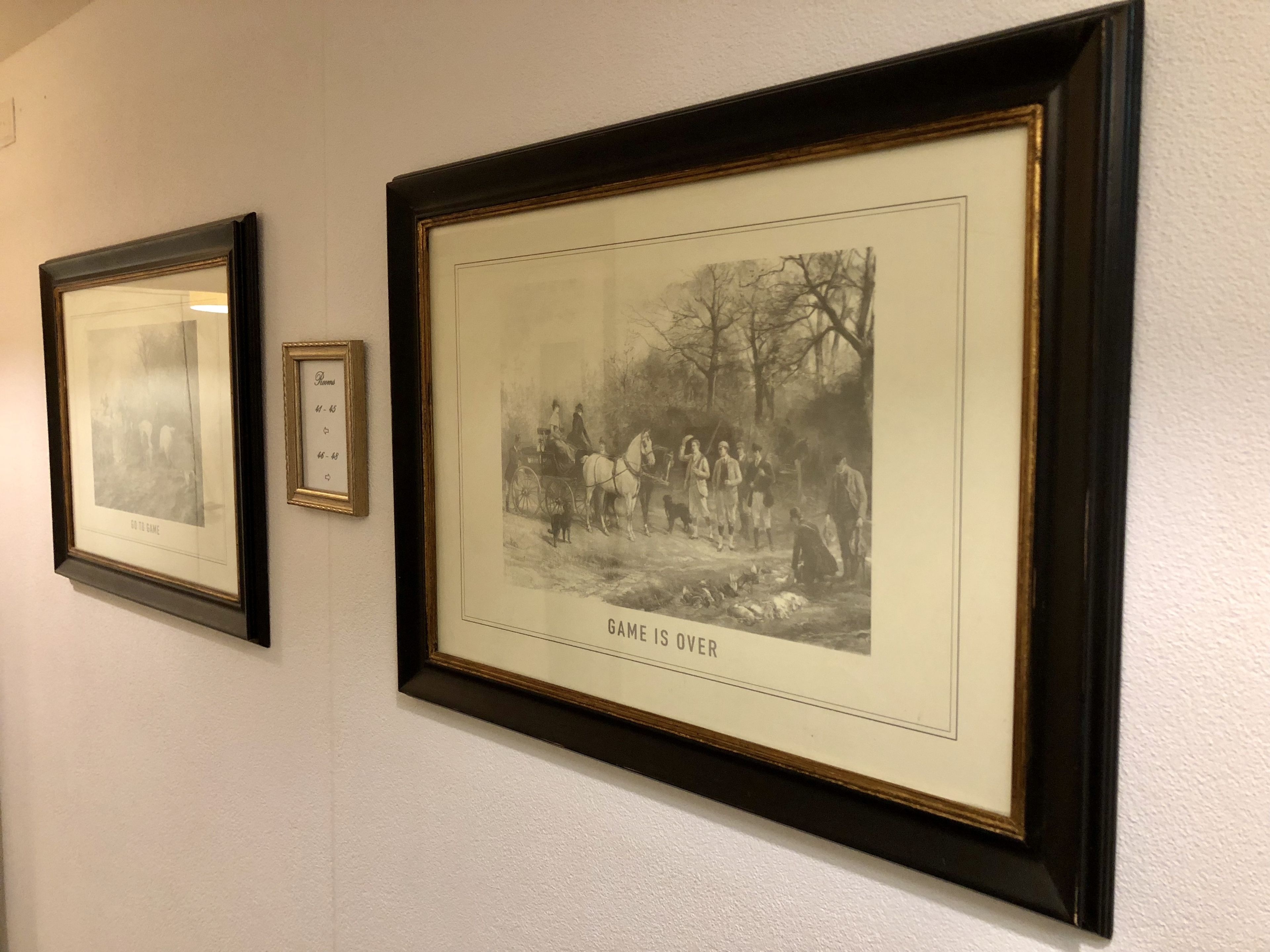 Two framed photographs on a wall.