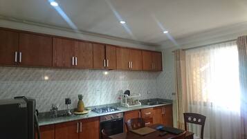 Premium Apartment, 1 Bedroom, Garden View, Garden Area | Private kitchen | Full-size fridge, microwave, oven, stovetop