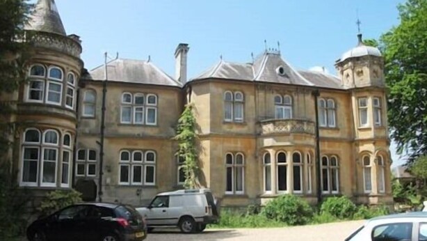 A historic building with a turret, large windows, and a gravel driveway. - Fieldways (Trowbridge)