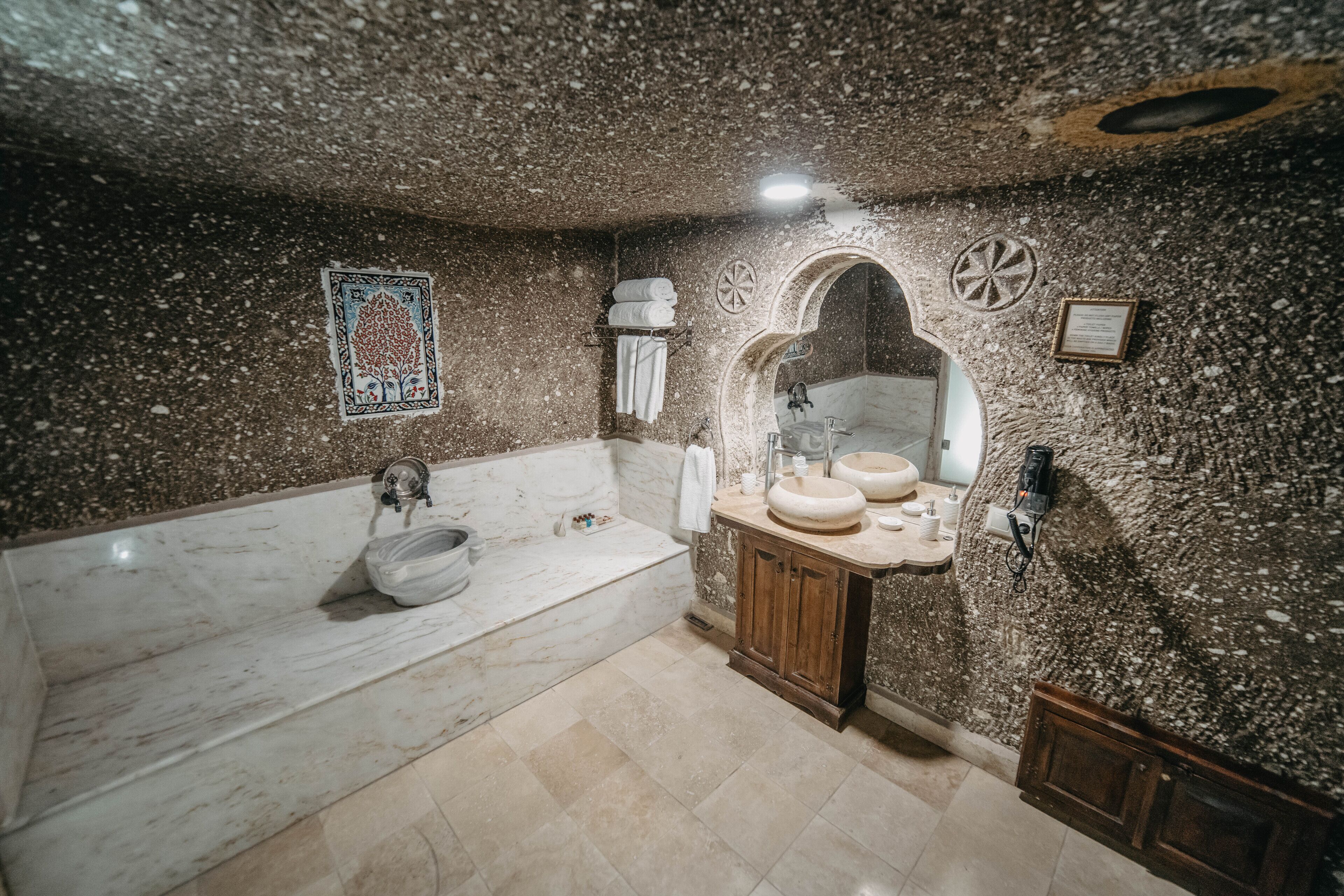 superior cave suite | bathroom | free toiletries, hair dryer, bathrobes, slippers