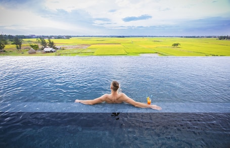 Outdoor pool, pool umbrellas, pool loungers. Lasenta Boutique Hotel Hoian