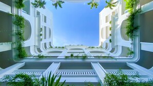 A modern architectural design with symmetrical buildings, green plants, and a clear blue sky. - Lasenta Boutique Hotel Hoian (Da Nang)