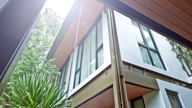 A modern building with large windows and a wooden ceiling. - Akanaka (Jakarta)