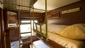 A bunk bed with a window, a sink, and a small shelf. - Train Lodge Amsterdam - Hostel (Amsterdam)