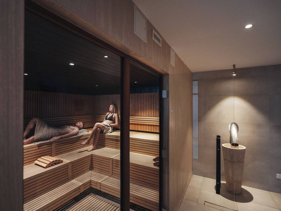 Een sauna met houten banken en een stenen pilaar.