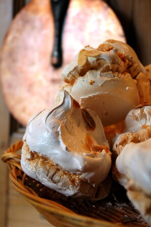 A basket of pastries with a creamy filling and a whole pastry in the background. - Hotel beau site (Malbuisson)