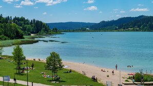 A lakeside park with picnic areas, a walking path, and a beach. - Hotel beau site (Malbuisson)
