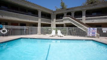 Relax by the pool surrounded by a secure fence, enjoy a refreshing swim and lounge on the provided chairs.