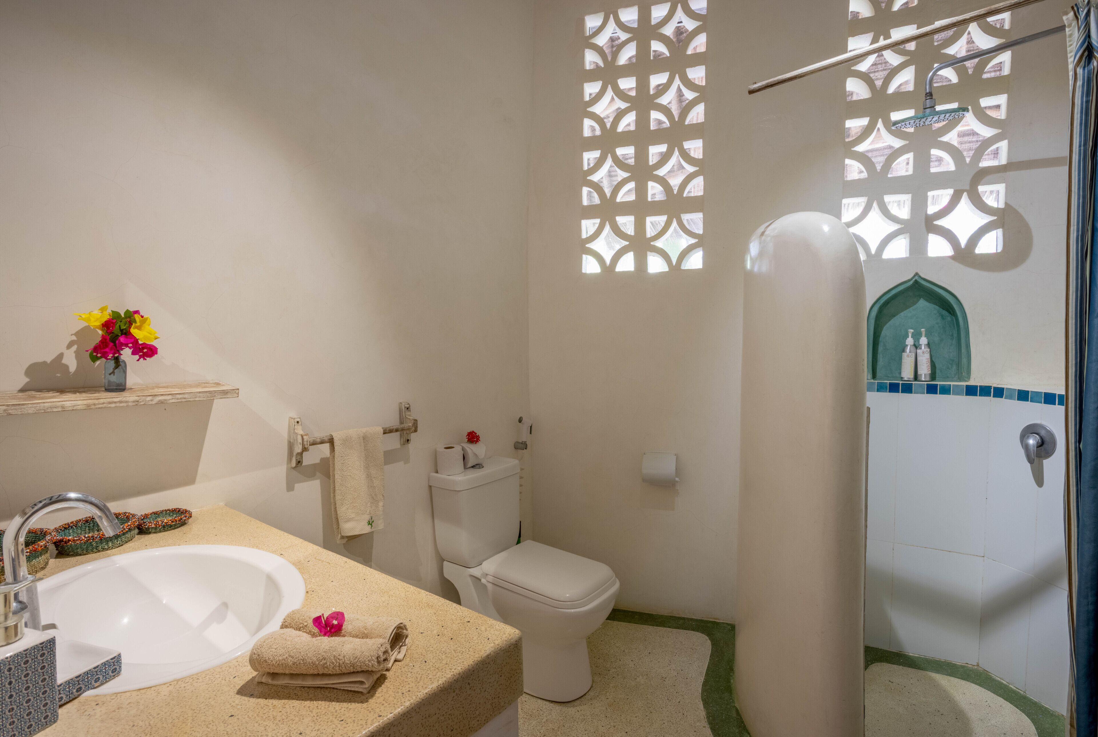 A bathroom with a sink, toilet, and shower.