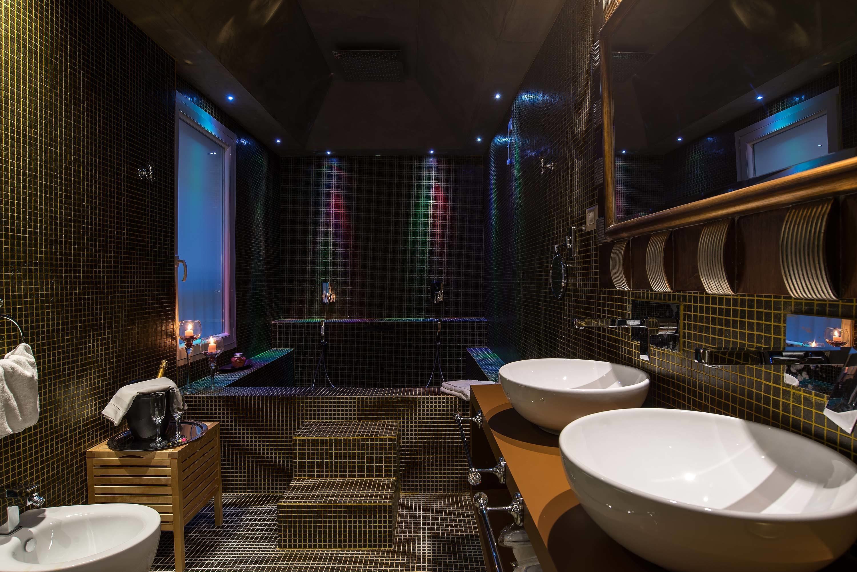 A modern bathroom with two sinks, a mirror, and a tiled floor.