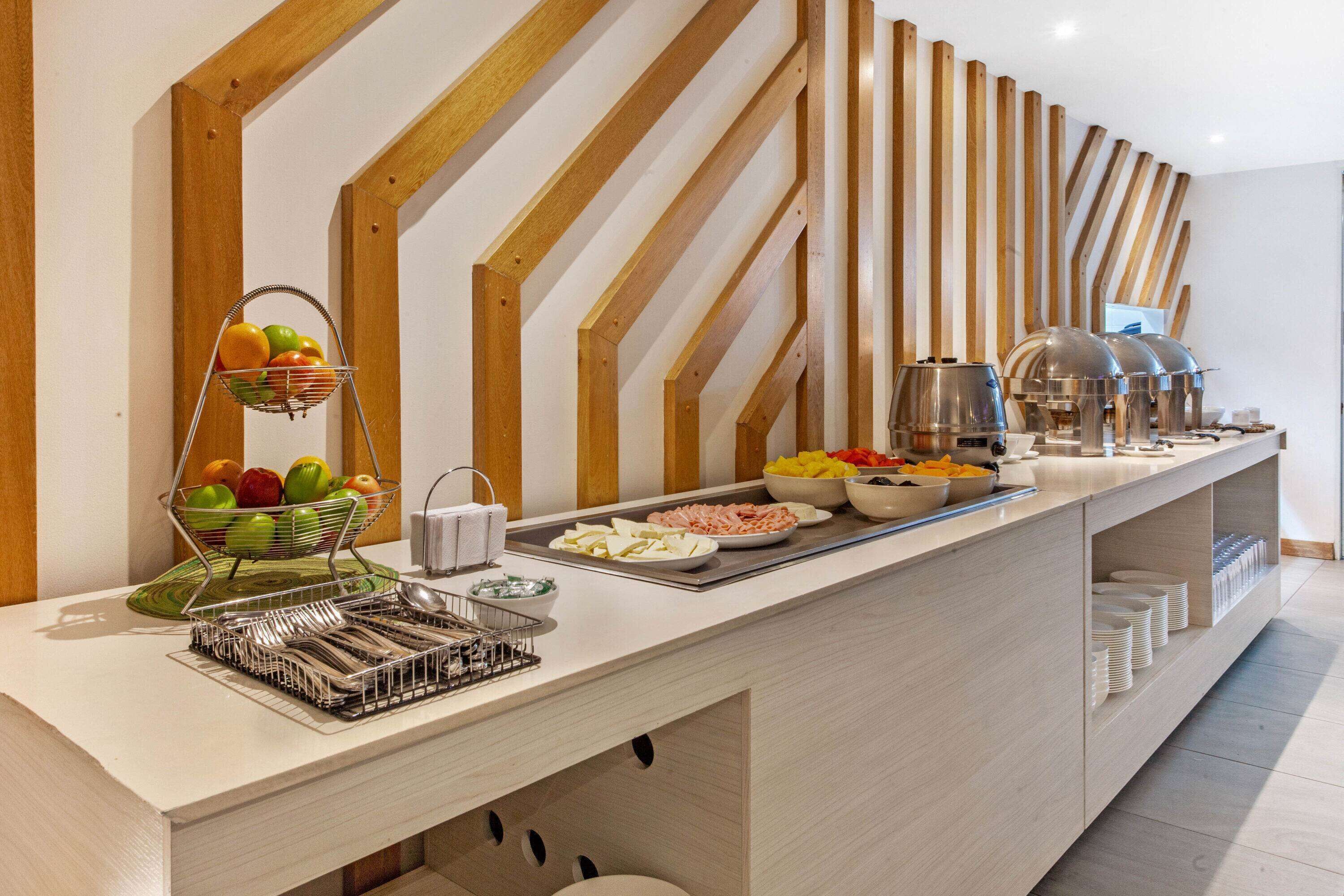 A buffet setup with various food items and utensils.