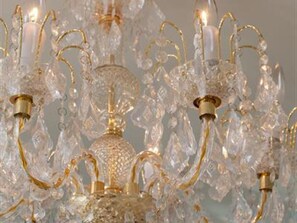 A chandelier with multiple crystal arms and light fixtures.