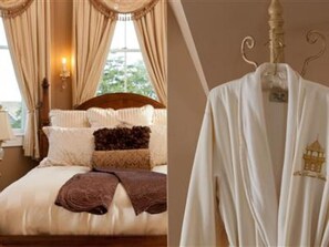 A neatly made bed with a brown throw blanket, a wooden headboard, and a hanging robe with a tag.