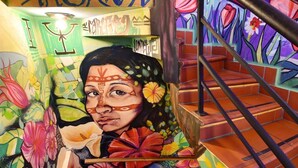 A staircase with vibrant floral murals and a handrail.