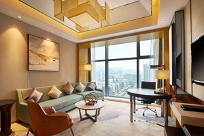 A modern hotel room with a large window offering a city view, a sofa, a coffee table, and a desk with a chair. - Doubletree By Hilton Ningbo Beilun (Ningbo)