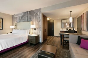 A modern hotel room with a large bed, a desk, a sofa, and a bathroom. - Embassy Suites by Hilton Berkeley Heights (Berkeley Heights)