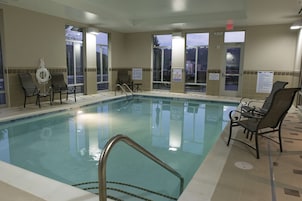 Una piscina techada, sillones reclinables de piscina