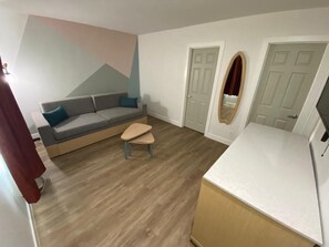 Deluxe Suite, 2 Bedrooms | Living area | Flat-screen TV