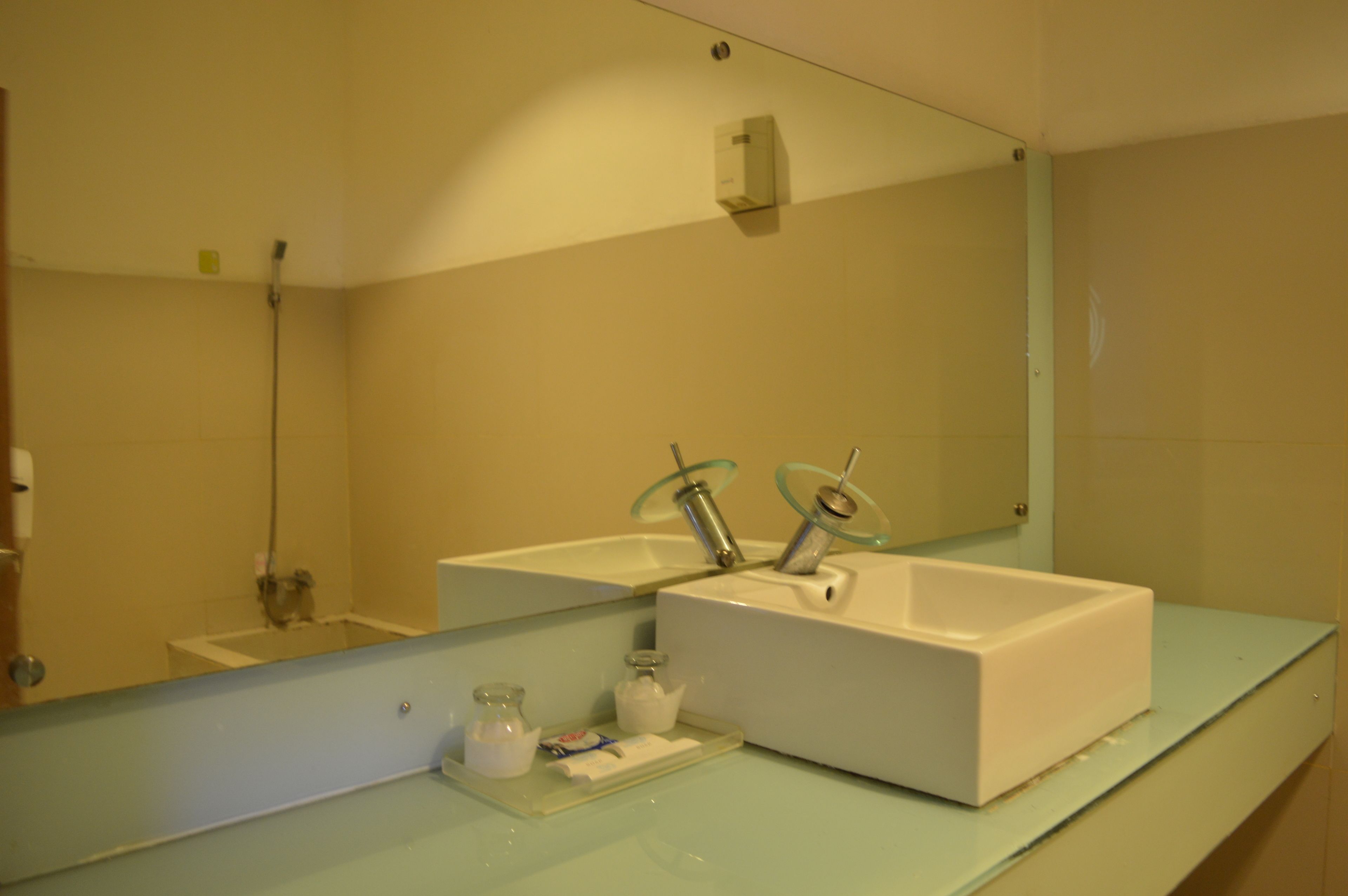 A bathroom with two sinks, a mirror, and a shower.