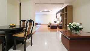 Una sala de estar moderna con comedor, un sofá, una mesita de centro y un mueble de madera.