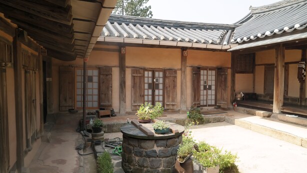 A traditional courtyard with stone walls, wooden doors, and tiled roofs. - Gyeamgotaek (Seosan)