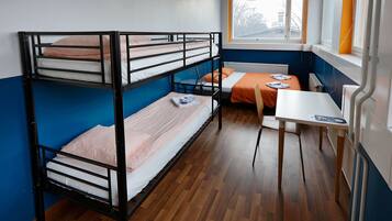 Un dormitorio con literas, un escritorio y una ventana con vistas.