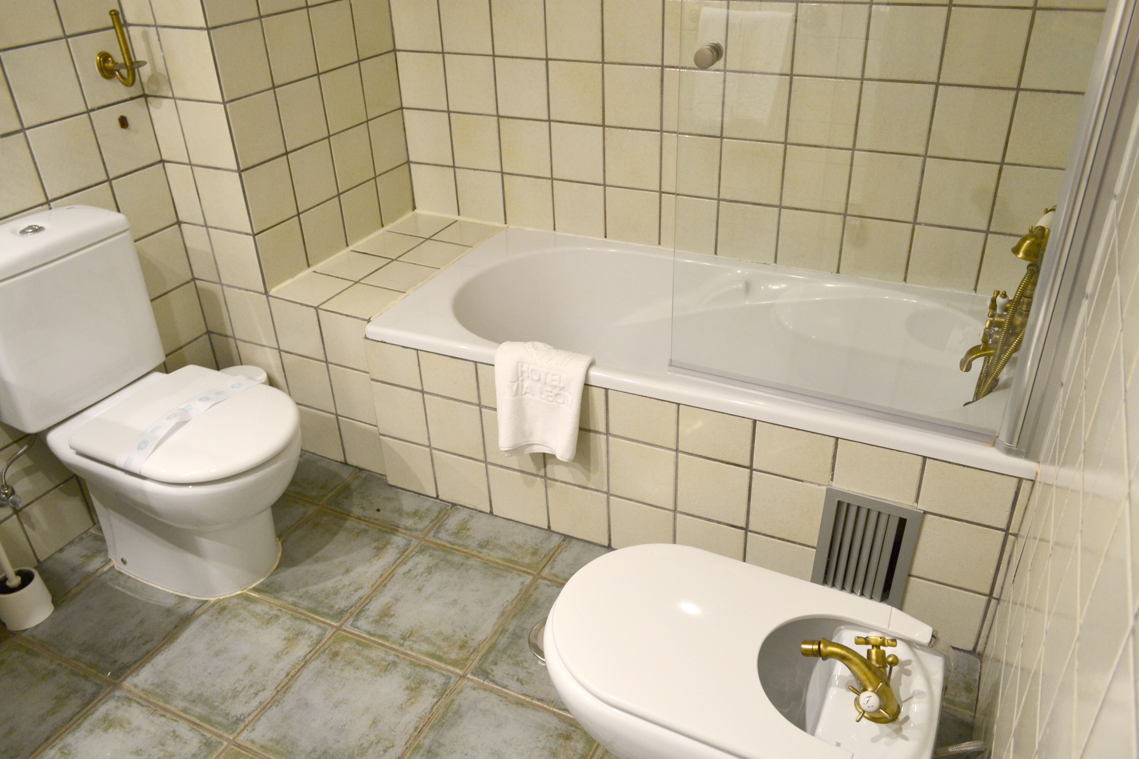 Un baño con inodoro, bañera y lavamanos.