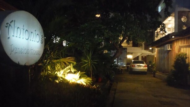 A nighttime view of a building entrance with a sign reading "Antonio's Pensionhouse." - Antonio's Pension House (Dipolog)