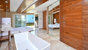 A modern bathroom with a large white bathtub, wooden ceiling beams, and a glass shower enclosure. - View 4 You Apartments (Podstrana)