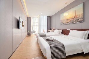 A hotel room with two beds, a large painting of the Eiffel Tower, a flat-screen TV, and a wooden floor. - Colour Inn Shenzhen Dongmen Branch (Shenzhen)