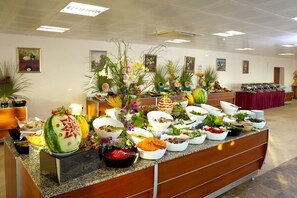 A buffet setup with various food items and decorative plants. - Gumuldur Resort Hotel & SPA (Menderes)