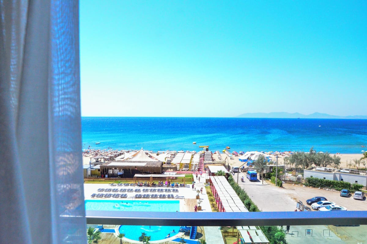 A resort with a pool, beach area, and ocean view.