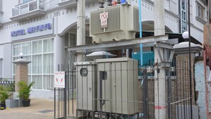 A hotel with a sign reading "HOTEL MAYMYC" and a large electrical box labeled "315" in front of it. - Hotel Maymyo (Pyin Oo Lwin)