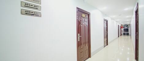 A long, narrow hallway with doors numbered 401-407 and 408-411.