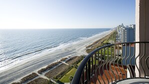 A balcony with a view of a beach and ocean. - Palms Resort (Myrtle Beach)