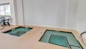 A swimming pool area with multiple lanes, each marked with a depth indicator. - Palms Resort (Myrtle Beach)