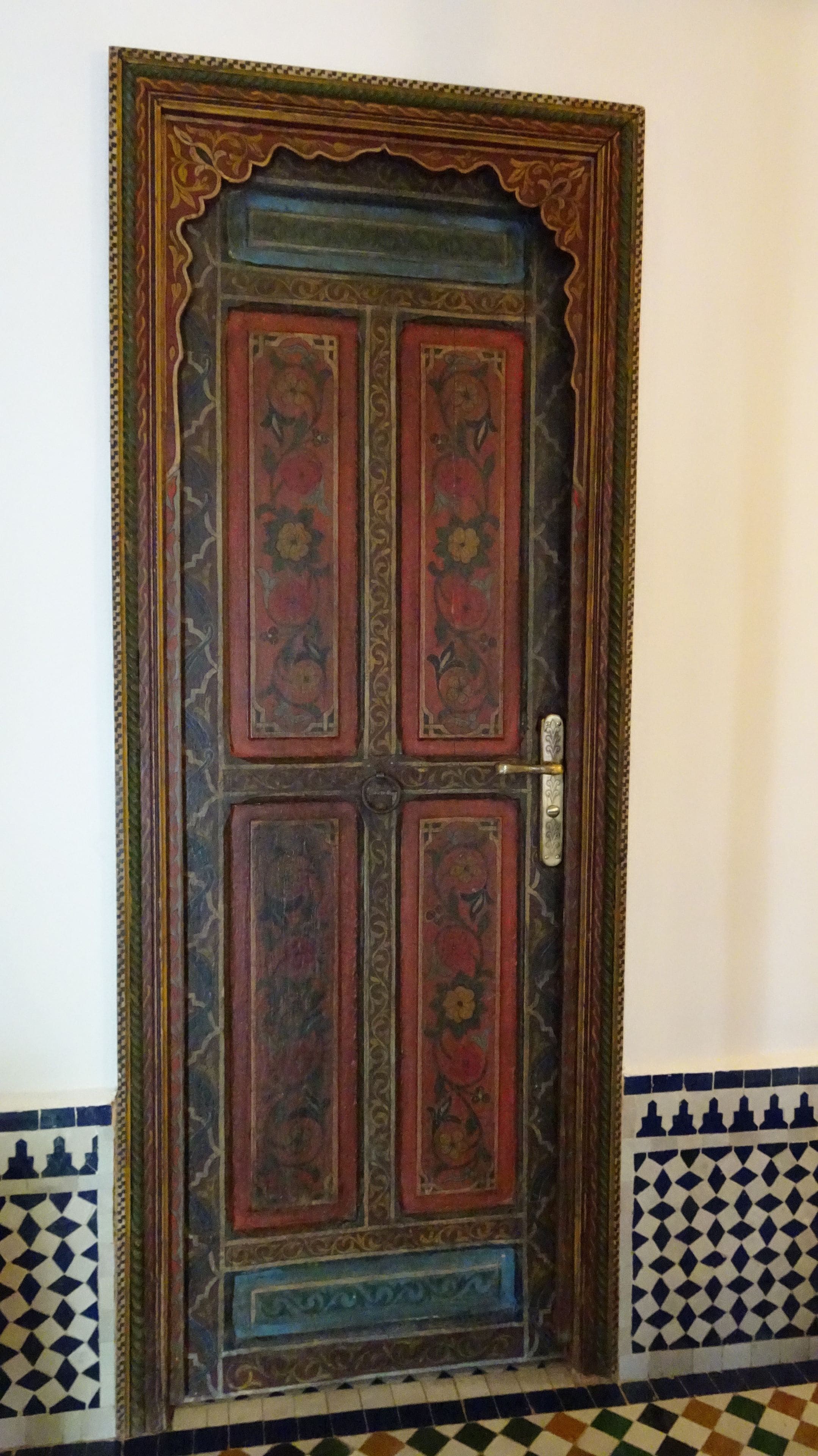 A traditional door with intricate floral patterns and a decorative frame.